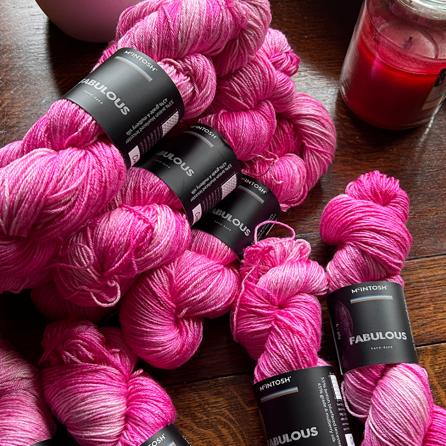 a pile of pink McIntosh skeins of wool