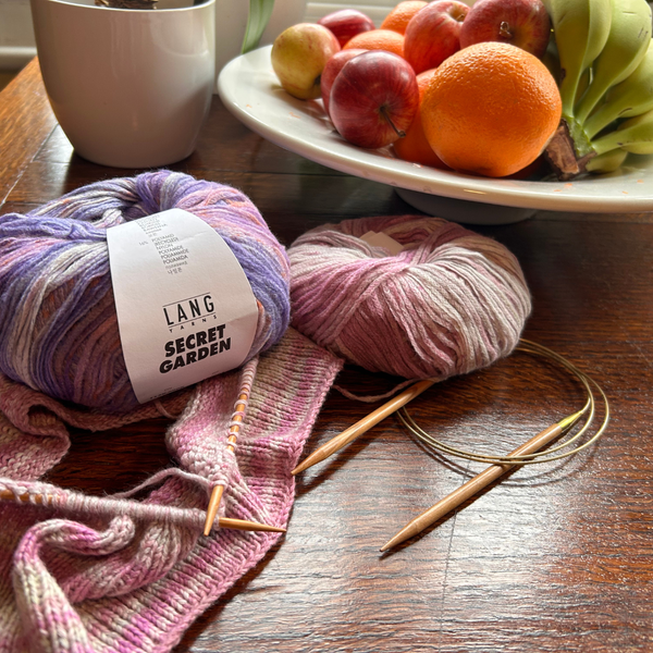 Knitting on a table with fruit bowl