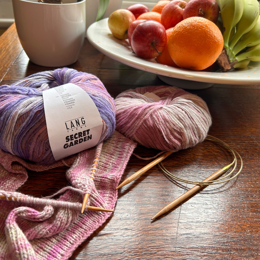 Knitting on a table with fruit bowl