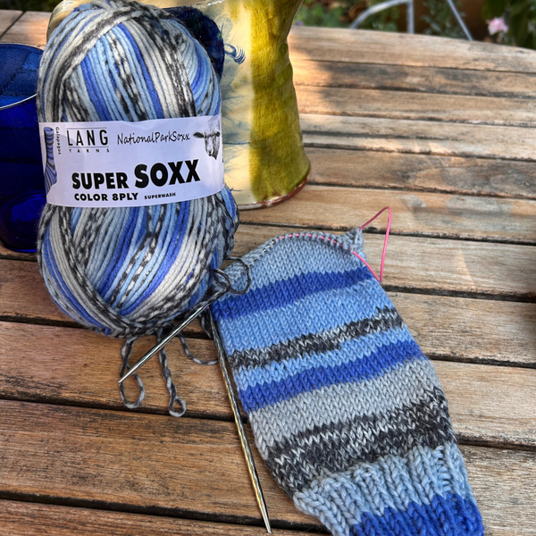 Close-up of knitted fabric showing the self-striping colour changes