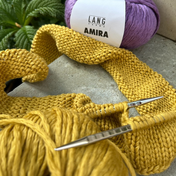 Close-up of knitted AMIRA fabric highlighting loft and stitch definition