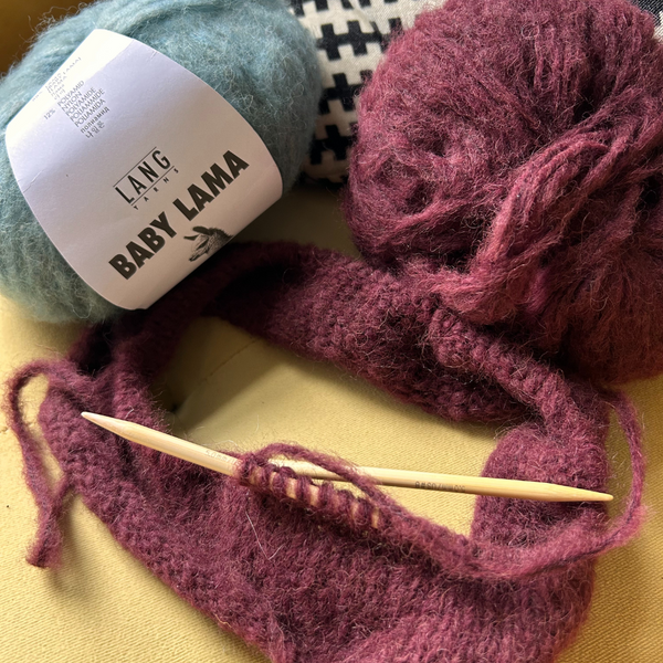 Close-up of BABY LAMA yarn ball showing soft halo and lustrous surface