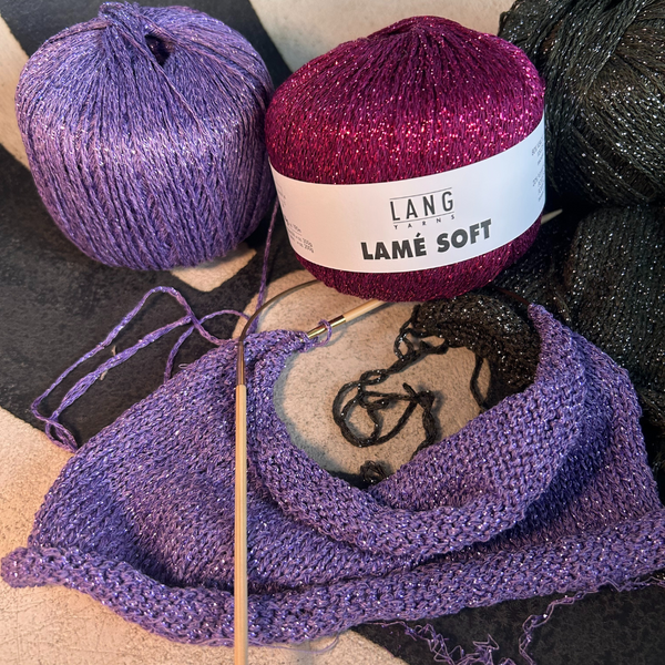 Ball of LAMÉ SOFT yarn showing metallic sheen in natural light