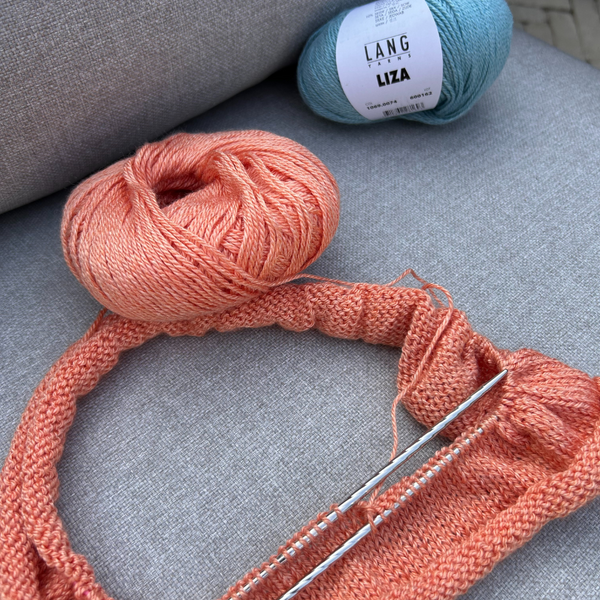 Close-up of knitted LIZA fabric displaying subtle colour variations and smooth stitch definition