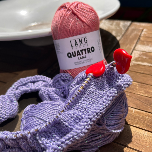 Close-up of knitted fabric in QUATTRO LAMÉ catching the light with subtle sparkle