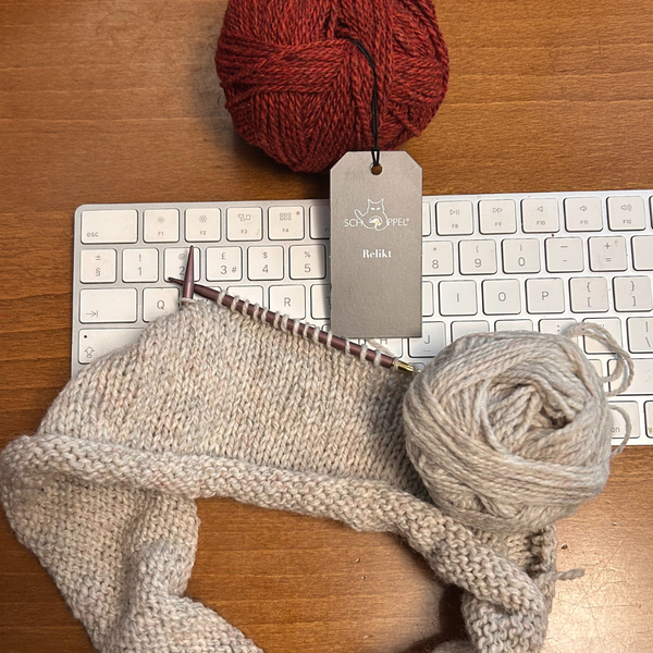 Knitting sitting on computer keyboard